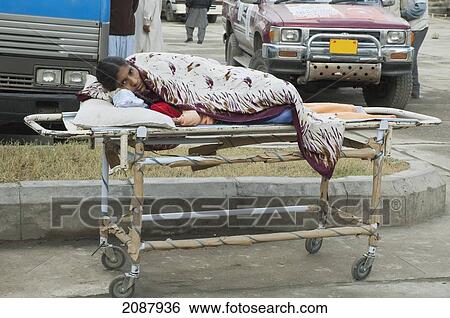 Patient On A Stretcher By A Polyclinic After The 8 October 2005 Earthquake, Muzaffarabad, Azad Kashmir, Pakistan View Large Photo Image Stock Photograph - Patient On A Stretcher By A Polyclinic After The 8 October 2005 Earthquake, Muzaffarabad, Azad Kashmir, Pakistan. Fotosearch