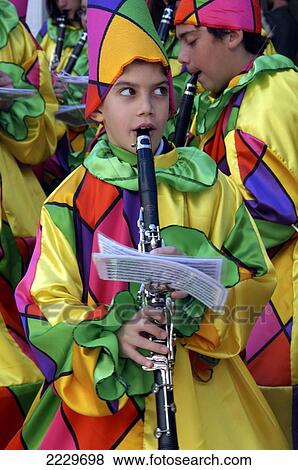 Stock Photo - Patras, Greece: A Boy In A Harlequin Costume Playing Clarinet In A Band During The Build Up To The City's Annual Carnival.. Fotosearch