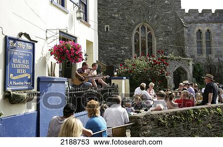 Patrons sitting on an outdoor patio of a pub; Kingswear, Devon, England View Large Photo Image Stock Image - Patrons sitting on an outdoor patio of a pub; Kingswear, Devon, England. Fotosearch