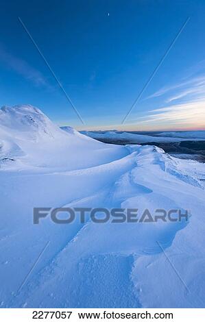 Stock Photo - Patterns in the snow on the summit of Beinn Respiol at dusk, Ardnamurchan peninsula; Highlands, Scotland. Fotosearch
