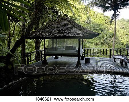 Stock Image - Pavilion By Pond In Mountain Area. Fotosearch