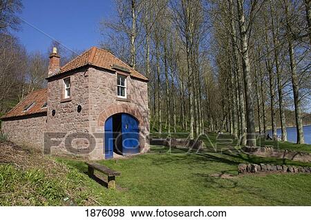 Stock Photo - Paxton, Northumberland, England; A Shed With A Blue Door By The Water. Fotosearch