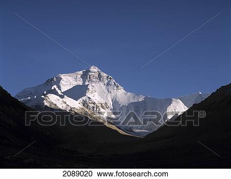 Stock Image - Peak Of A Snow Covered Mountain Against A Blue Sky. Fotosearch