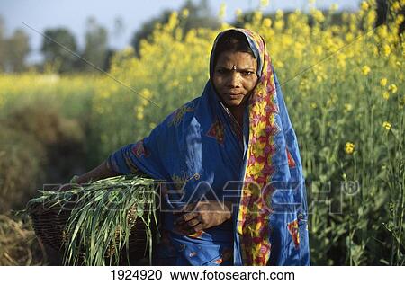 Stock Image - Peasant Woman In Poor Rural Area. Fotosearch