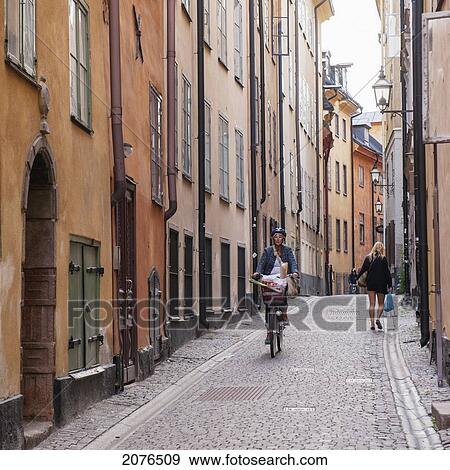 Stock Photo - Pedestrian And Cyclists On A Narrow Street; Stockholm Sweden. Fotosearch