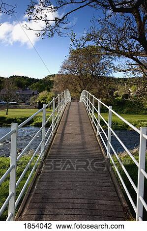 Stock Image - Pedestrian Bridge, Rothbury; Northumberland, England. Fotosearch