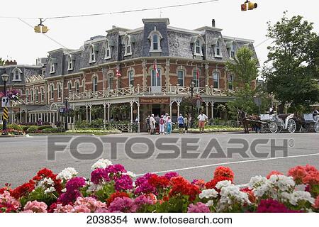Pedestrians And A Horse And Carriage On A Street In A Quaint Town; Niagara On The Lake Ontario Canada View Large Photo Image Picture - Pedestrians And A Horse And Carriage On A Street In A Quaint Town; Niagara On The Lake Ontario Canada. Fotosearch