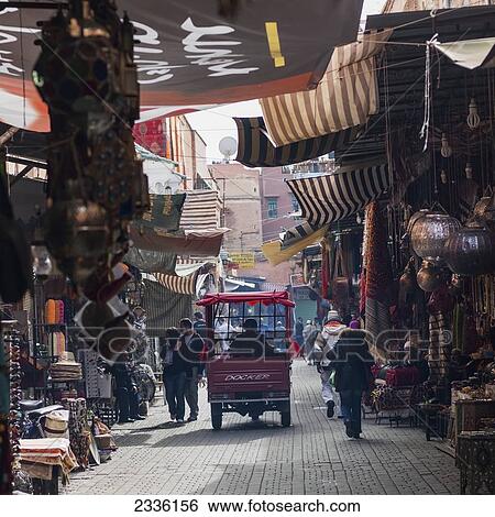 Pedestrians And A Small Vehicle In A Street Lined With Wares For Sale; Marrakesh, Marrakech-Tensift-El Haouz, Morocco View Large Photo Image Stock Photograph - Pedestrians And A Small Vehicle In A Street Lined With Wares For Sale; Marrakesh, Marrakech-Tensift-El Haouz, Morocco. Fotosearch