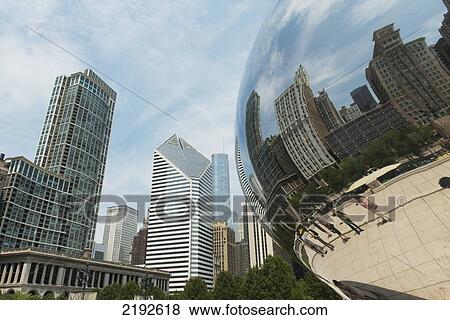 Stock Photo - Pedestrians And Buildings Reflected In A Metal Curved Sculpture; Chicago Illinois United States Of America. Fotosearch