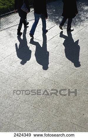 Pedestrians and their shadows on a walkway; Paris, France View Large Photo Image Stock Photo - Pedestrians and their shadows on a walkway; Paris, France. Fotosearch