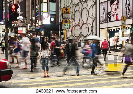 Stock Image - Pedestrians crossing a street; Hong Kong, China. Fotosearch
