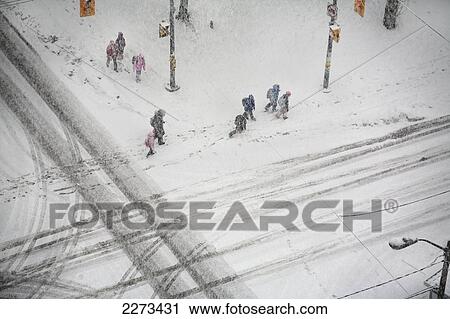 Stock Image - Pedestrians in a winter storm; toronto ontario canada. Fotosearch