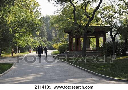 Stock Photography - Pedestrians On A Walkway Through An Urban Park; Beijing China. Fotosearch