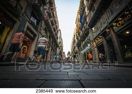 Pedestrians on the narrow street; Barcelona, Catalonia, Spain View Large Photo Image Stock Photo - Pedestrians on the narrow street; Barcelona, Catalonia, Spain. Fotosearch