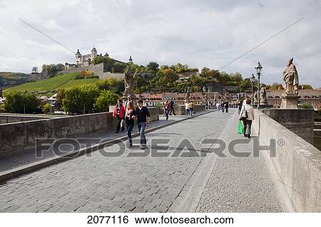 Pedestrians On The Old Bridge Over Main River; Wuerzburg Bavaria Germany View Large Photo Image Stock Photograph - Pedestrians On The Old Bridge Over Main River; Wuerzburg Bavaria Germany. Fotosearch