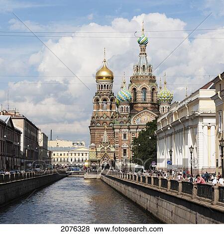 Pedestrians On The Promenade Along The Griboedova Canal With Church Of The Savior On Spilled Blood In The Distance; St. Petersburg Russia View Large Photo Image Stock Photo - Pedestrians On The Promenade Along The Griboedova Canal With Church Of The Savior On Spilled Blood In The Distance; St. Petersburg Russia. Fotosearch