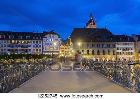Stock Photography - Pedestrians over a bridge on Lake Lucerne; Lucerne, Switzerland. Fotosearch