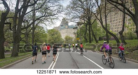 Stock Image - Pedestrians, runners and cyclists on a park path; New York City, New York, United States of America. Fotosearch