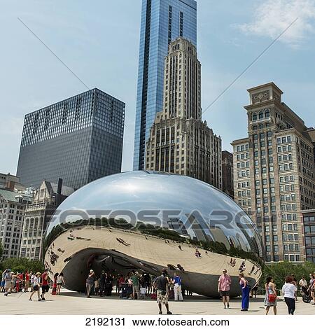Stock Image - Pedestrians Standing By A Metallic Rounded Sculpture Reflecting The Skyscrapers Around It; Chicago Illinois United States Of America. Fotosearch
