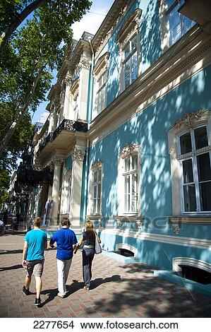 Pedestrians walk by a blue historic building in Odessa city centre; Odessa, Ukraine View Large Photo Image Picture - Pedestrians walk by a blue historic building in Odessa city centre; Odessa, Ukraine. Fotosearch