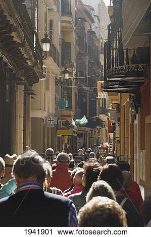 Stock Image - Pedestrians Walking On A Typical Busy Street; Malaga Malaga Province Spain. Fotosearch