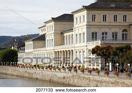 Stock Image - Pedestrians Walking On The Promenade Along The River Lahn; Bad Ems Rheinland-Pfalz Germany. Fotosearch