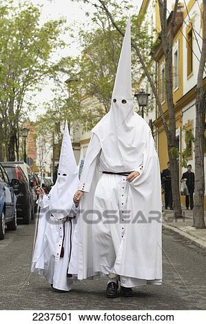 Stock Image - Penitentes Of The Brotherhood Of The Peace Of Sevilla Outside The Iglesia De San Sebastian; Seville Spain. Fotosearch