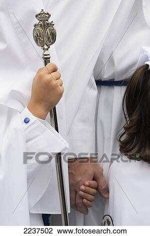 Stock Image - Penitentes Of The Brotherhood Of The Peace Of Sevilla Outside The Iglesia De San Sebastian; Seville Spain. Fotosearch