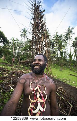 Pentecost chief stands before a land diving tower; Pentecost Island, Vanuatu View Large Photo Image Stock Photo - Pentecost chief stands before a land diving tower; Pentecost Island, Vanuatu. Fotosearch