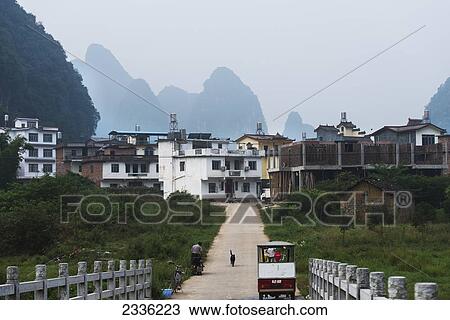 People And A Cat On A Path In A Residential Area With Mountain Peaks In The Distance; Guilin, Guangxi, China View Large Photo Image Stock Image - People And A Cat On A Path In A Residential Area With Mountain Peaks In The Distance; Guilin, Guangxi, China. Fotosearch