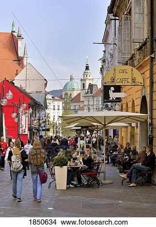 Picture - People At A Street Cafe In A Busy City. Fotosearch