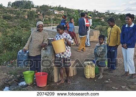 Stock Photo - People At A Water Well In Fianarantsoa, Madagascar. Fotosearch
