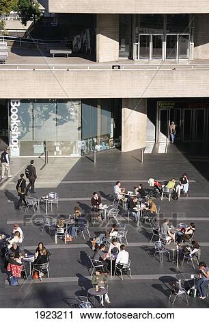 Stock Image - People At Cafe Outside Swiss Re Tower, London, England. Fotosearch