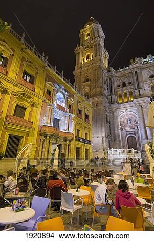 People At Cafe Tables In Square In Front Of Cathedral And Palacio Episcopal At Night, Malaga, Andalucia, Spain View Large Photo Image Picture - People At Cafe Tables In Square In Front Of Cathedral And Palacio Episcopal At Night, Malaga, Andalucia, Spain. Fotosearch