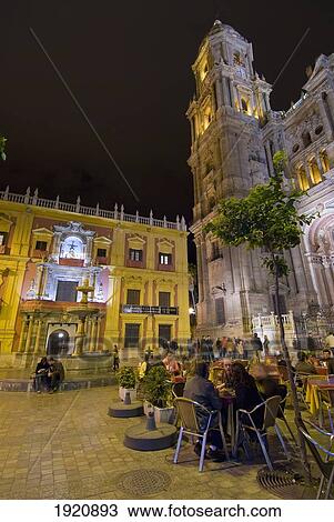 People At Cafe Tables In Square In Front Of Cathedral And Palacio Episcopal At Night, Malaga, Andalucia, Spain View Large Photo Image Stock Image - People At Cafe Tables In Square In Front Of Cathedral And Palacio Episcopal At Night, Malaga, Andalucia, Spain. Fotosearch