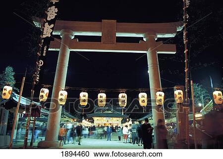 Stock Image - People At Gogokujinja Shrine During Hatsumode Celebration At Night. Fotosearch