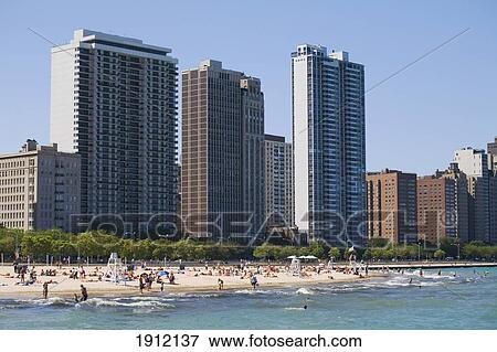 People At Oak Street Beach With High Rise Buildings In Background, Chicago, Illinois, Usa View Large Photo Image Stock Photo - People At Oak Street Beach With High Rise Buildings In Background, Chicago, Illinois, Usa. Fotosearch