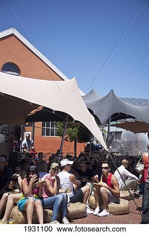 Stock Image - People At The Old Biscuit Mill Weekend Market, Albert Road, Woodstock Area, Cape Town; The Old Biscuit Mill Weekend Market, Albert Road, Woodstock Area, Cape Town, South Africa. Fotosearch