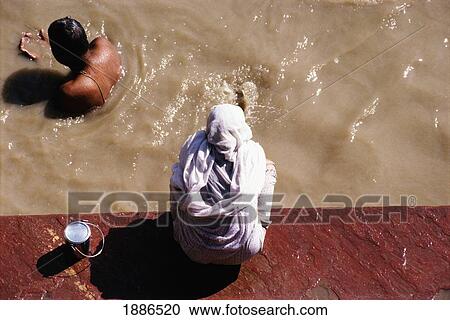 Stock Image - People Bathing In Jamuna River. Fotosearch