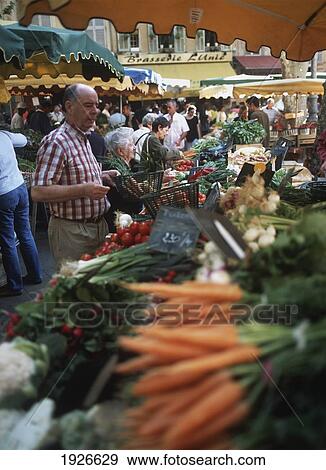 Stock Photo - People Buying Produce In Market. Fotosearch