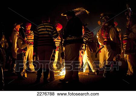 People collecting around small fire during a break in procession at East Hoathly Bonfire Night; East Sussex, England View Large Photo Image Stock Photo - People collecting around small fire during a break in procession at East Hoathly Bonfire Night; East Sussex, England. Fotosearch