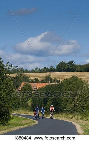 People Cycling Along Country Road View Large Photo Image Picture - People Cycling Along Country Road. Fotosearch