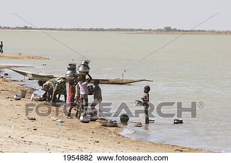 Stock Image - People doing laundry in the Niger River at Sebi, Mali. Fotosearch