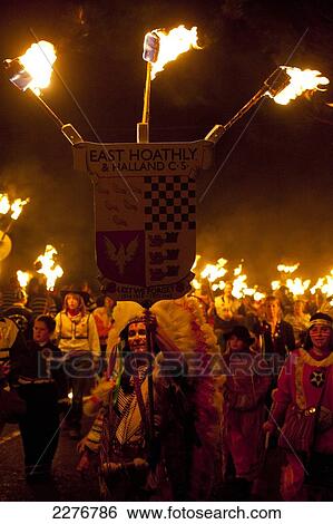 Stock Photograph - People dressed as American Indians walking in procession for East Hoathly Bonfire Night; East Sussex, England. Fotosearch