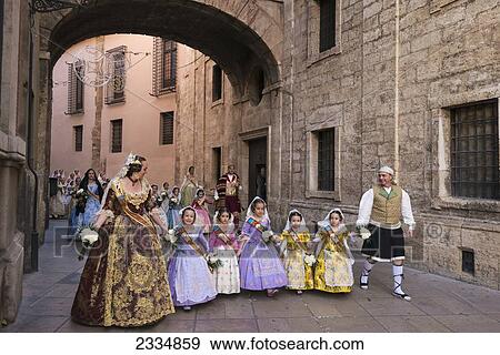 Stock Photo - People Dressed Up In Traditional Casal Faller Outfits In Procession With Flower Offering For Virgin De Los Desamparados At Fallas Festival; Valencia, Spain. Fotosearch