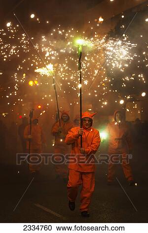 Stock Image - People Dressing As Devils In Fire Parade During Fallas Festival; Valencia, Spain. Fotosearch