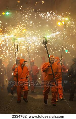 Stock Image - People Dressing As Devils In Fire Parade During Fallas Festival; Valencia, Spain. Fotosearch