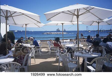 People Eating And Drinking Outside At A Beach Bar Along The Croisette, Cannes View Large Photo Image Stock Photo - People Eating And Drinking Outside At A Beach Bar Along The Croisette, Cannes. Fotosearch