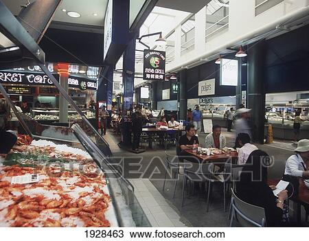 Stock Image - People Eating In The Fish Market. Fotosearch
