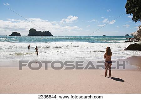 People Enjoying Holidays On Beach; New Zealand View Large Photo Image Picture - People Enjoying Holidays On Beach; New Zealand. Fotosearch